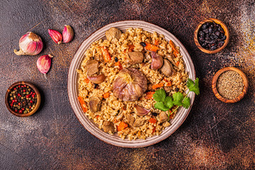 Pilaf with meat, vegetables and spices.