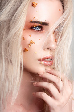 Beautiful blonde woman with creative make up art