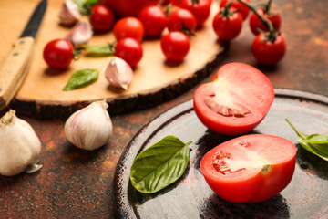 Plate with fresh tomatoes on grunge background