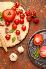Composition with fresh tomatoes on grunge background