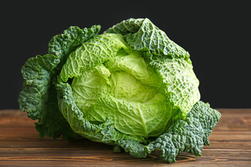 Fresh savoy cabbage on wooden table