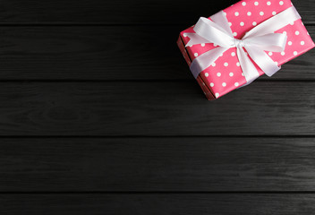 top view of a gift box on a black wooden background