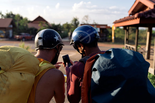 Friends backpackers traveling on motorbike scooter