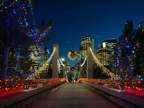 A bridge into a downtown core decorated for Christmas.