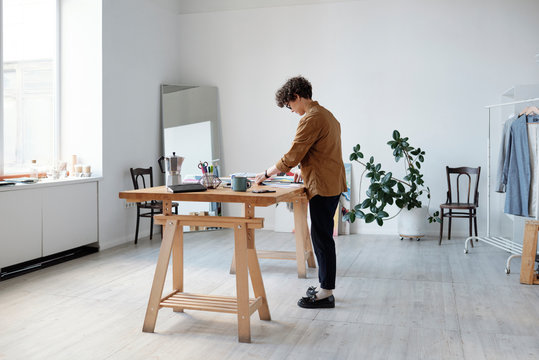 Woman working on art collages in studio