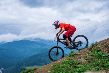 Fototapeta premium Cyclist riding a mountain bike from a mountain.