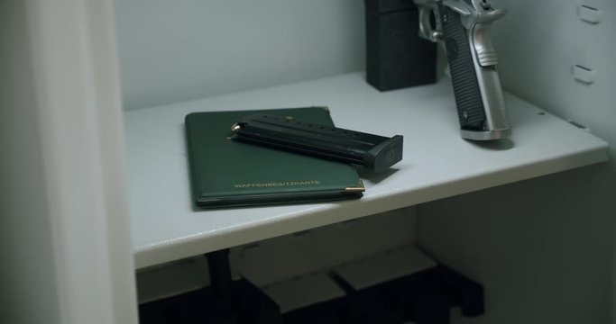 Opening and closing a german gun safe. Taking a gun magazine out of a safe and putting it back in.