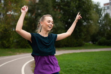 Athletic girl, on a treadmill, having fun and smiling.