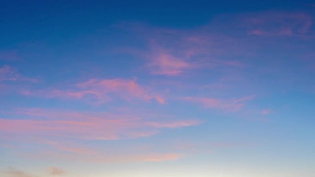 4k time lapse of light pink clouds at sunrise, beautiful background footage great for over lays of text for intro, copy space, shot in marbella, spain