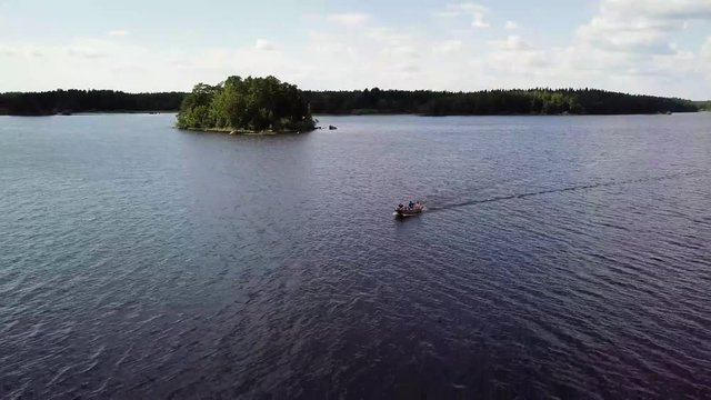 Aerial footage of a boat on the lake in the Färnebofjärdens Nationalpark in Sweden.
