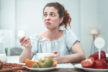 Curly woman with skin rash having allergy to some food