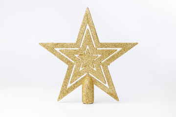 Golden Christmas star on white background. Christmas decor and toys.