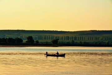 Obraz na płótnie Canvas a boat with fishermen on the Danube