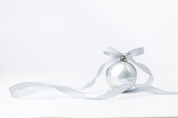 Christmas balls with silver ribbon on white background. Christmas decor and toys. 