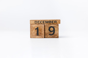 Business and design concept - geometric floating wooden cube on white background. Desember Calendar.