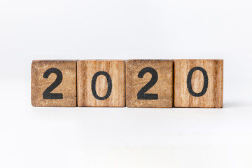 Business and design concept - geometric floating wooden cube on white background. 2020 year.