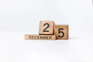 Business and design concept - geometric floating wooden cube on white background. 25th Desember. Christmas.