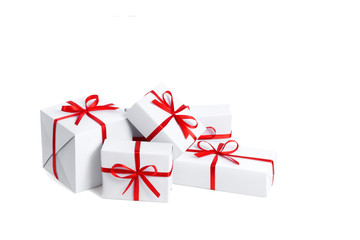 Side view of a set of five festive white gift boxes tied with a red satin ribbon with a bow with empty place for text isolated on white background