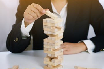 .Planning risk and strategy in businessman gambling placing wooden block.Business concept for...