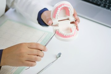 Dentist examining a patient teeth medical treatment at the dental office