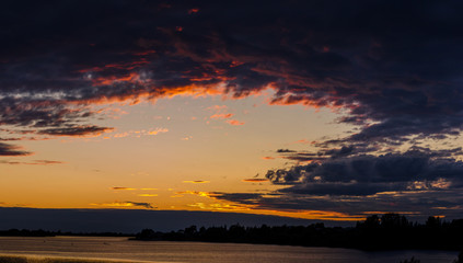 Beautiful dramatic sky. Sunset time. Orange and lilac.