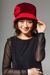 Naklejka premium Asian girl in red hat, smiling
