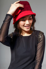 Asian girl in red hat, smiling