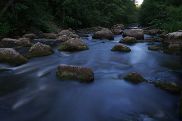 Water streaming in river in summer night