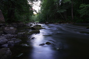 Water streaming in river in summer night