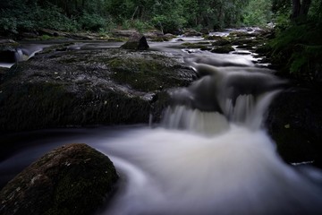 Water streaming in river in summer night