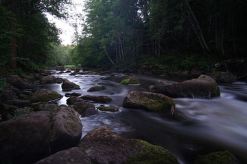 Water streaming in river in summer night