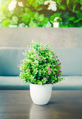 Interior decoration, Artificial flower in white ceramic vase with windows light (vintage tone)