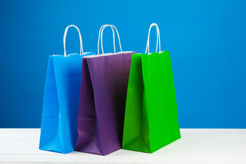 Arrangement of shopping bags on blue background