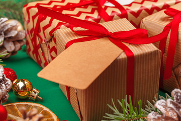 Craft christmas gifts with red ribbons on decorated christmas background
