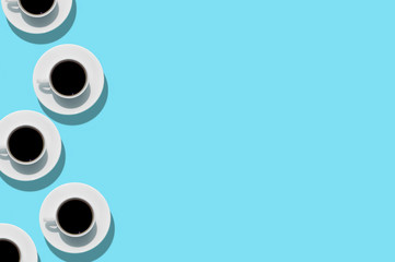 Cups with coffee on aquamarine background. Free space. Isolated. Top view.