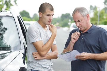 young man passing driving license exam