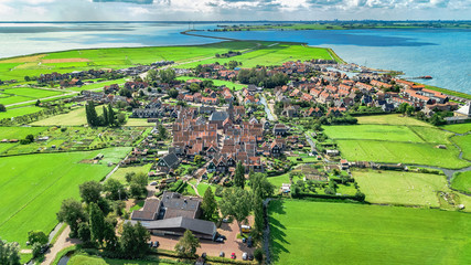 Aerial drone view of Marken island, traditional fisherman village from above, typical Dutch landscape, North Holland, Netherlands