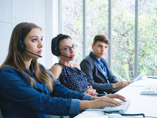 friendly operator team agent with headsets working in a call centre