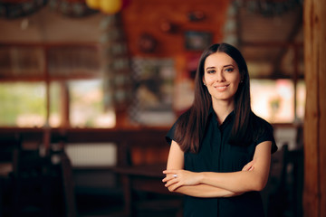 Manager Standing in a Restaurant Welcoming Customers