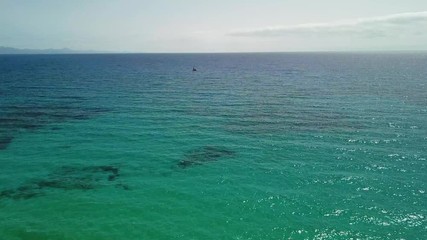 Above vertical view of blue ocean waves and yellow sandy beach - summer holiday vacation concept - travel and scenic place - energy nature outdoors with nobody there