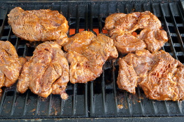 fresh stakes grilling on the gas barbecue