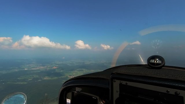 Adventure of flying, pilots point of view from the cockpit of light aircraft, compas with magnetic windrose on dashboard, freedom above the clouds