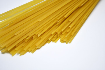 Raw Italian spaghetti pasta on white background.