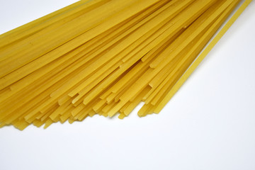 Raw Italian spaghetti pasta on white background.