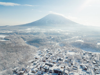 Winter in Niseko, Japan. A Blue bird kind of day at Grand Hirafu, Niseko Ski Resort. Photos were taken with a drone overlooking the Grand Hirafu area with views of Mt. Niseko-Annupuri. and Mt. Yotei.