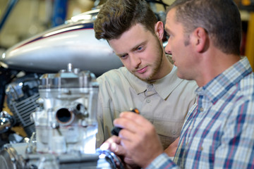 pleasant concentrated engineeers examining robot