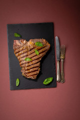 Grilled T-bone beef steak on slate