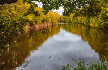 Autumn park on the banks of the canal