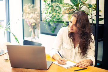 Female student in her 30s making a course online. E-learning lessons. 