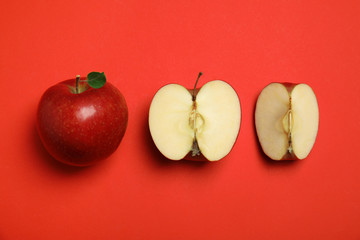 Flat lay composition with ripe juicy apples on red background